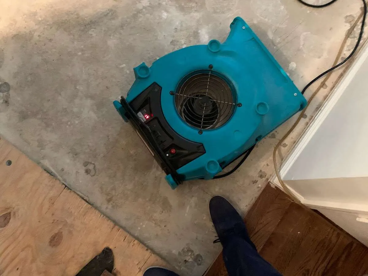 Air mover drying subfloor during Commercial Water Damage Restoration in Pine Ridge